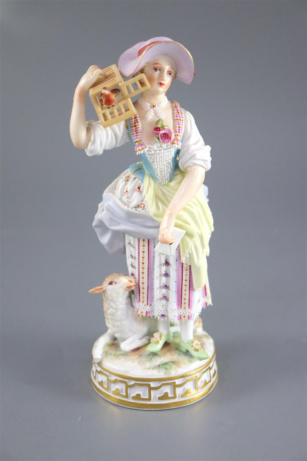 A Meissen figure of a shepherdess releasing a bird from a cage, 19th century, 17.5cm high